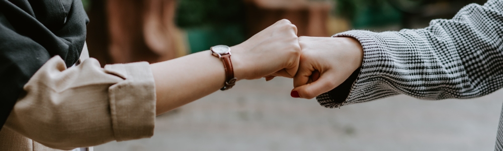 two people bumping fists