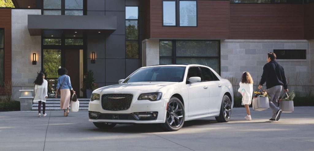 Family with their white 2023 Chrysler 300