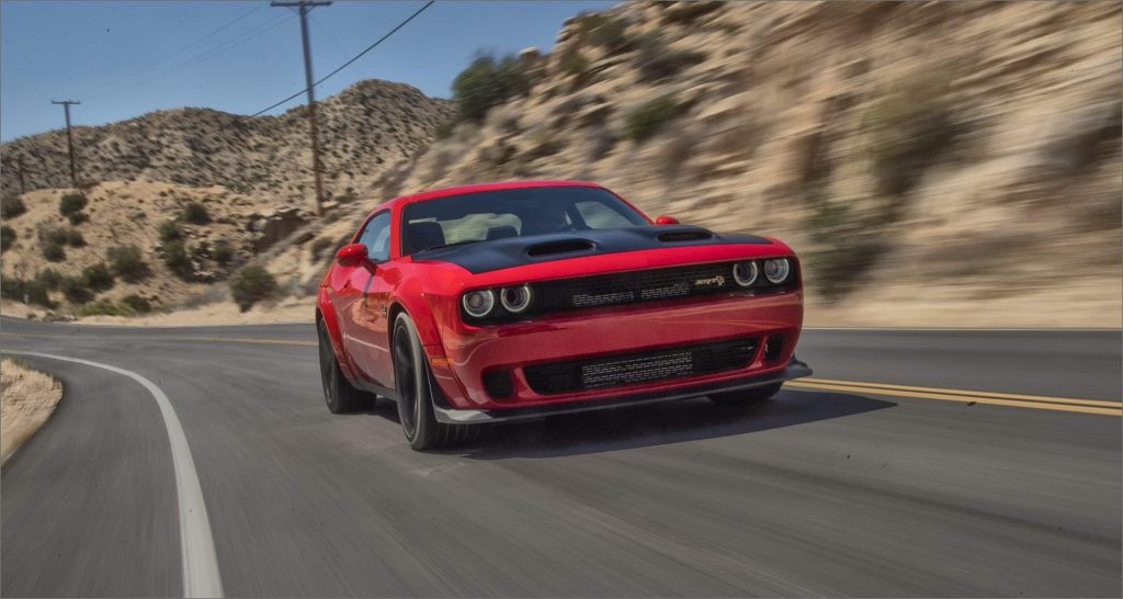 Dodge Challenger SRT Hellcat making waves on the road and burning rubber.