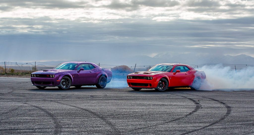 2024 Dodge Challengers leaving tread on the road and burning out on the track.