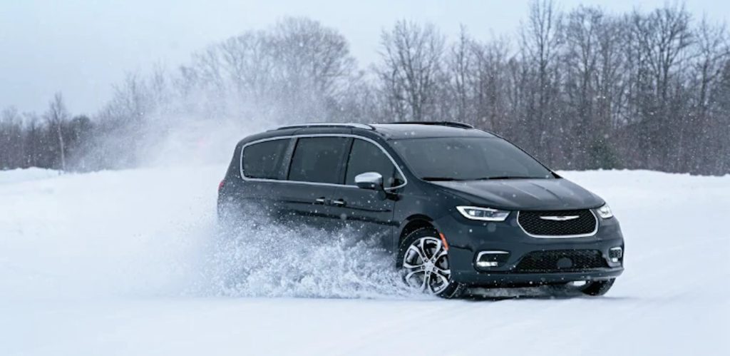 Chrysler Town Pacifica navigating deep snow with its winter tires in a snowy forrest