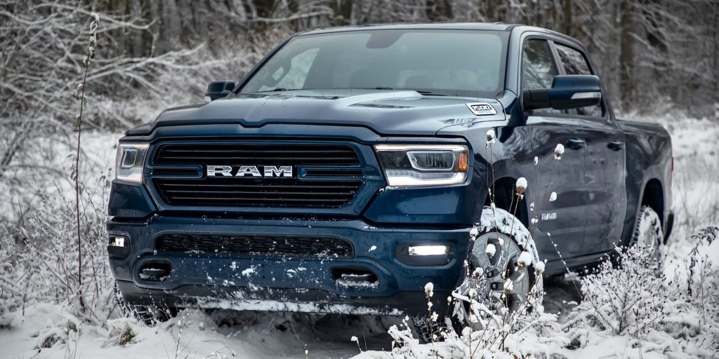 Ram 1500 Navigates off-road through a snowy forest in its winter tires.