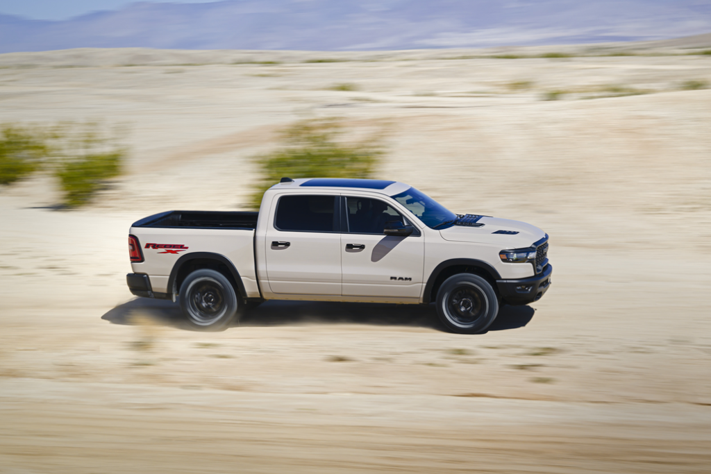 Ram 1500 Rebel Driving Through a Desert Side View