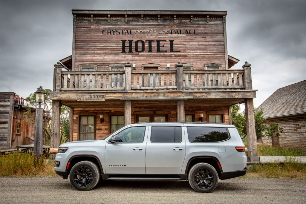 The Adaptable Grand Wagoneer Parked Outside A Western-Styled Hotel