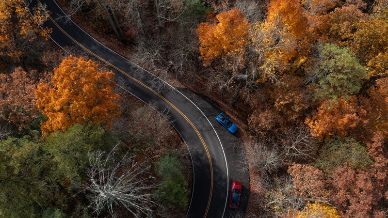 Two vehicles driving in Superior, WI in Autumn