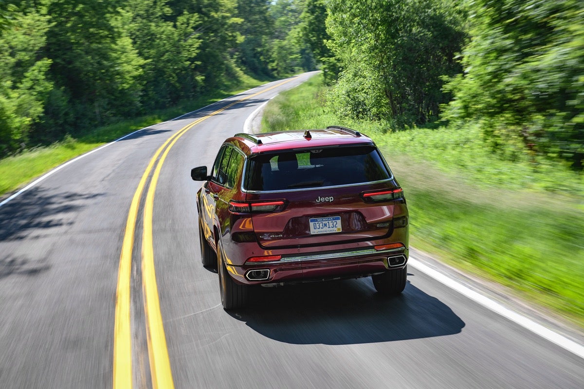 2021 Jeep Grand Cherokee L red rear forest highway
