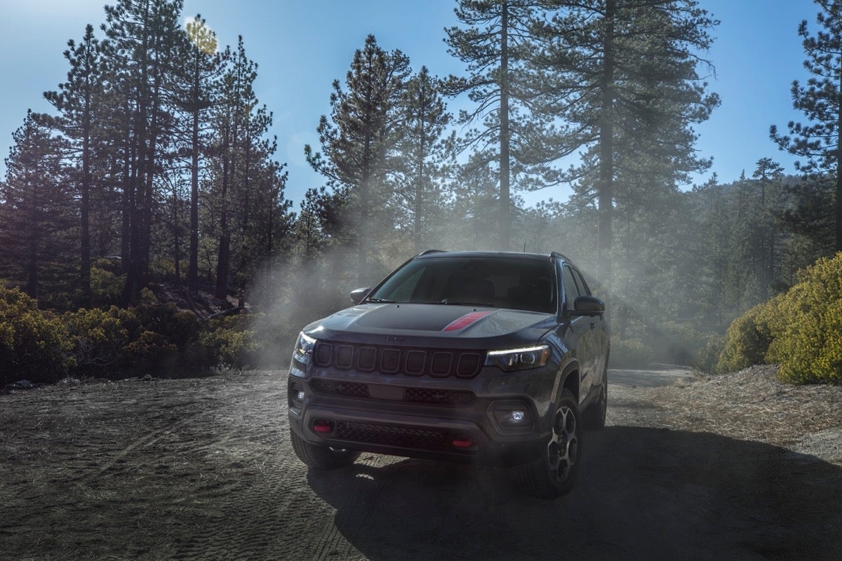 2022 Jeep Compass Trailhawk dusty trail through mountain pass