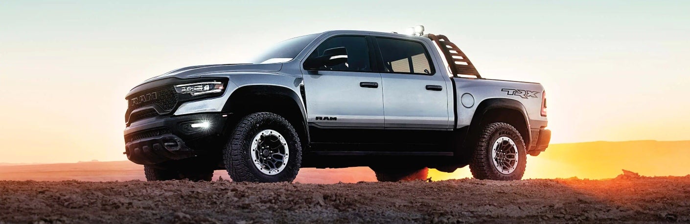 Silver 2023 Ram 1500 side view at sunset